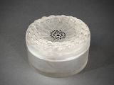 a clear glass container with a flower design on it