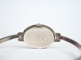 an image of a close up of a wrist watch on a white surface