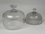two clear glass jars with lids sitting on a white surface