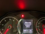 a car dashboard with a red light on it
