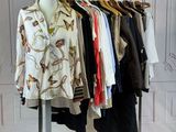 a lot of clothes hanging on a rack in a room