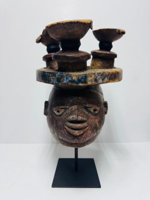 an image of a sculpture of a man ' s head with bowls on it