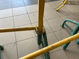 a close up view of a yellow and green bike rack