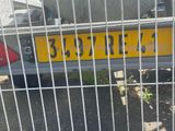 a yellow license plate on the back of a car