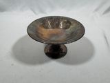 a small metal bowl on a stand on a white background