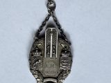 a silver pendant with a lock on it on a chain
