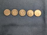 four different types of gold coins on a blue cloth