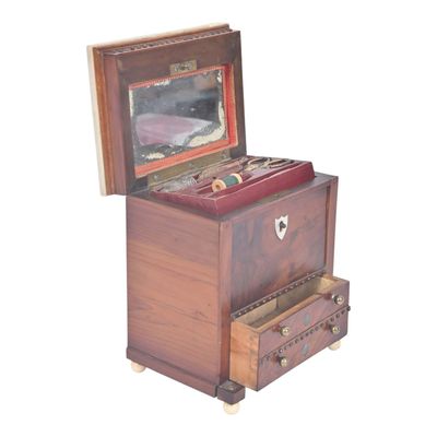 a small wooden box with a mirror on top of it