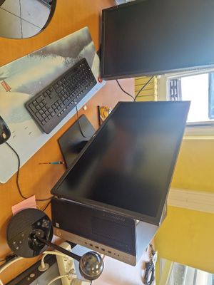 a computer desk with a monitor, keyboard, mouse and monitor