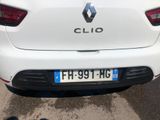 a close up of a white car parked in a parking lot