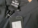a label on the back of a jacket on a hanger