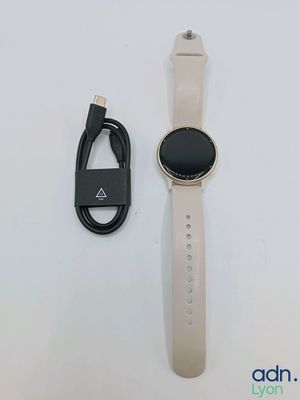 a close up of a smart watch with a cable connected to it