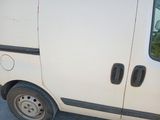 a small white van parked on the side of the road