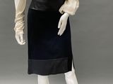 an image of a mannequin wearing a black skirt and white shirt