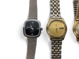 three different types of watches are displayed on a white surface