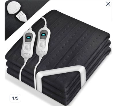 a picture of a blanket with a pair of remotes plugged into it