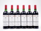six bottles of red wine are lined up in a row