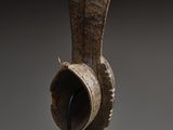 a close up of a sculpture of a vase on a stand