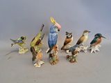 several figurines of birds sitting on top of each other