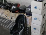 several boxes of helmets are stacked on top of each other