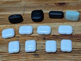 many white and black airpods sitting on a wooden table