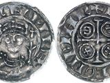 a close up of two silver coins on a white surface