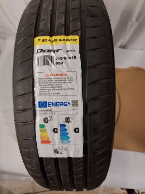 a close up of a tire on a bed with a label on it
