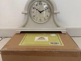 a clock sitting on top of a box on the floor