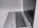 a silver laptop with a blue sticker on the screen