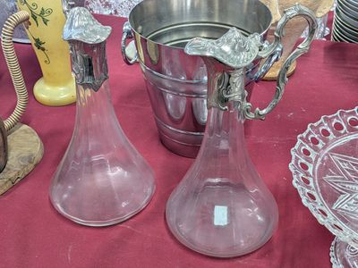 two glass vases on the table next to each other