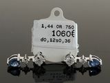 pair of sapphire and diamond earrings with price tag on black surface