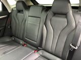 the back seats of a car with black leather and red trims