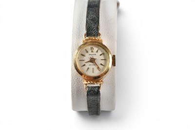 an image of a close up of a wrist watch on a white surface