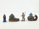 toy figurines of a man, a woman, and a man in a boat