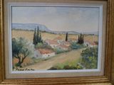 an oil painting of a landscape with houses and trees in a gold frame