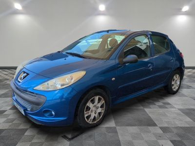 a blue car is parked on a checkered floor in a garage