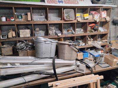 a cluttered garage with a lot of items on the shelves