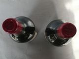 two bottles of wine that are sitting on a table