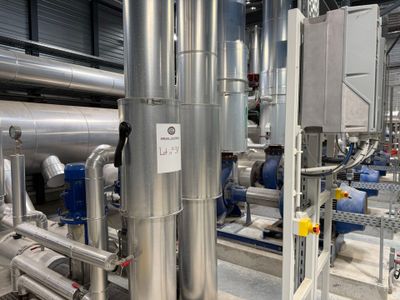 pipes and valves in a large industrial building with a lot of pipes