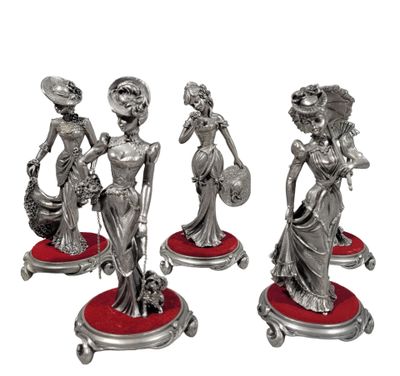 three silver figurines of a woman with a basket of flowers