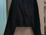 a black skirt hanging on a wall in a room