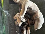 a statue of a man sitting on top of a table