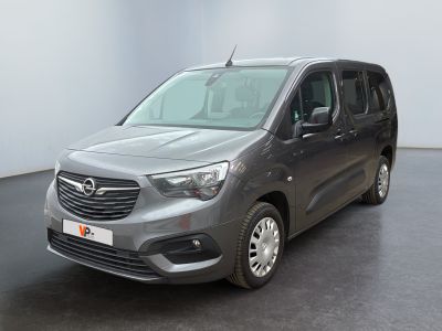 the grey van is parked in a large room with a black floor