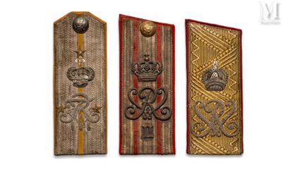 three military insignias are displayed on a white background