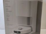 boxed box of a white coffee maker sitting on top of a counter