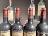 several bottles of wine are lined up in a row on a shelf