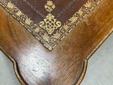 a wooden table with a brown leather cover on it