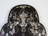 a black chair with a floral design on it