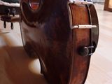 a wooden violin case sitting on the floor in a living room