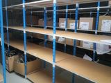 many shelves that have boxes on them in a room